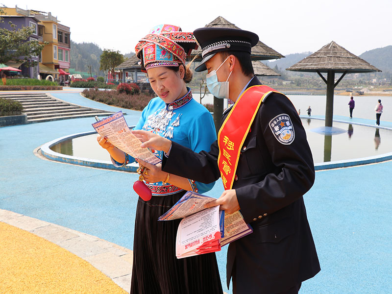 图为民警驻足向驻地少数民族群众宣讲法律知识.JPG