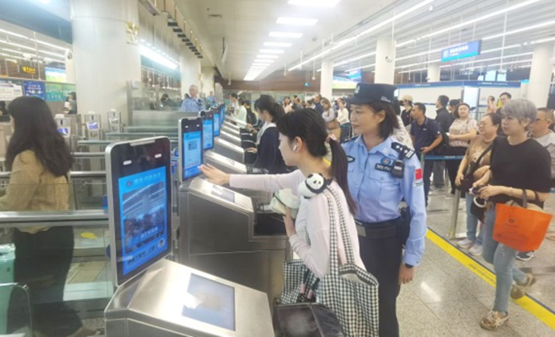皇岗边检站民警在福田口岸入境大厅智能快捷通道区域指导旅客“刷脸”快速通关体验.jpg