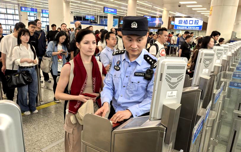 皇岗边检站民警在福田口岸出境大厅引导旅客正确刷脸快捷通关1.jpg